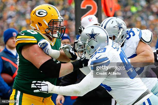 Lang of the Green Bay Packers confronts George Selvie of the Dallas Cowboys in the third quarter during the 2015 NFC Divisional Playoff game at...