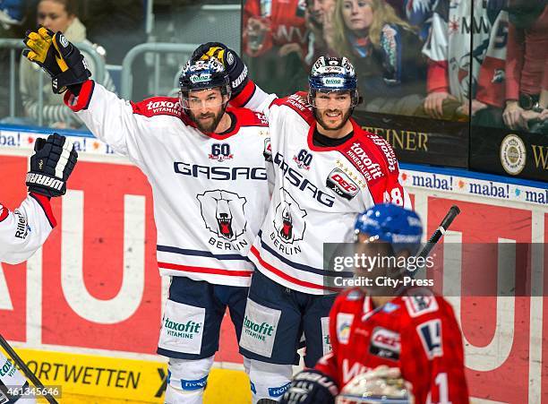 Julian Talbot and Darin Olver of the Eisbaeren Berlin celebrate during the game between Adler Mannheim and Eisbaeren Berlin on January 11, 2015 in...