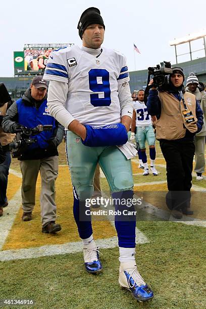 Tony Romo of the Dallas Cowboys walks off the field after losing 26-21 to the Green Bay Packers during the 2015 NFC Divisional Playoff game at...