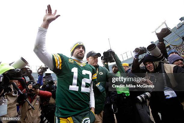 Quarterback Aaron Rodgers of the Green Bay Packers waves to the crowd after the Packers defeat the Dallas Cowboys 26-21 during the 2015 NFC...