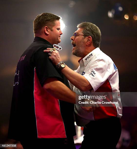 Scott Mitchell of England is congratulated by Martin Adams of England as he celebrates winning the mens final against Martin Adams of England during...