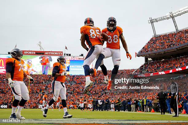 Demaryius Thomas celebrates a first quarter touchdown with Virgil Green of the Denver Broncos against the Indianapolis Colts during a 2015 AFC...