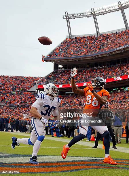 Demaryius Thomas of the Denver Broncos catches a touchdown in the first quarter as LaRon Landry of the Indianapolis Colts defends during a 2015 AFC...