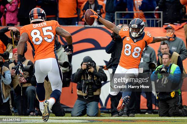 Demaryius Thomas of the Denver Broncos celebrates a first quarter touchdown with Virgil Green during a 2015 AFC Divisional Playoff game against the...