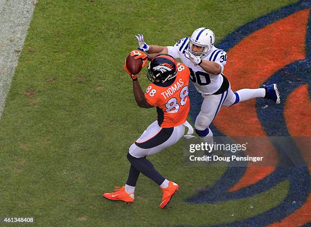 Demaryius Thomas of the Denver Broncos makes a touchdown catch under coverage by LaRon Landry of the Indianapolis Colts in the first quarter during a...