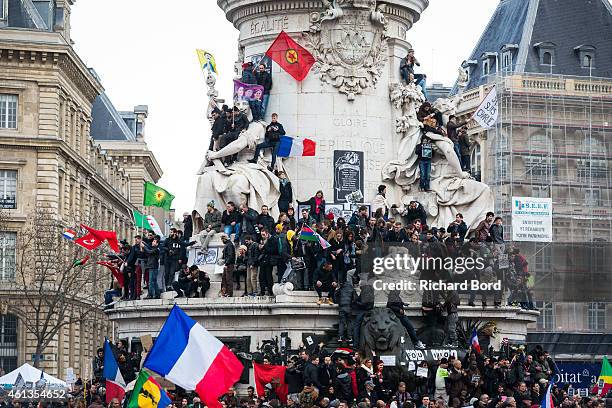 People stand in front of the 'Statue de la Republique' prior to a unity rally in Paris led by French president Francois Hollande and other world...