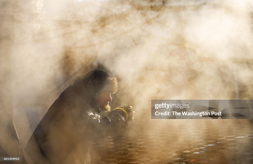 WASHINGTON, DC - JANUARY 7:   A homeless man warms himself on t