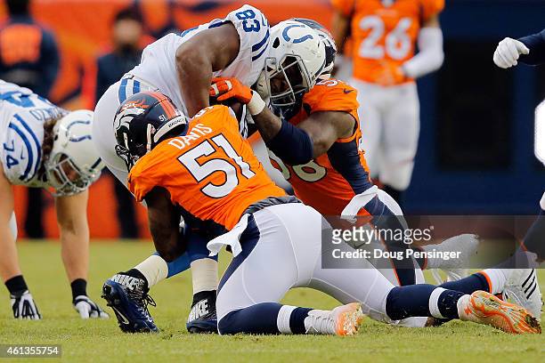 Dwayne Allen of the Indianapolis Colts is tackled by Todd Davis and Von Miller of the Denver Broncos during a 2015 AFC Divisional Playoff game at...