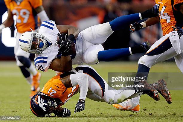 Zurlon Tipton of the Indianapolis Colts comes down with a catch onto the body of Aqib Talib of the Denver Broncos during a 2015 AFC Divisional...