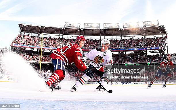 Jay Beagle of the Washington Capitals defends Jonathan Toews of the Chicago Blackhawks in the slot area in the second period of the 2015 Bridgestone...