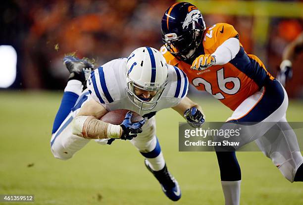 Jack Doyle of the Indianapolis Colts dives after a catch as Rahim Moore of the Denver Broncos covers the play during a 2015 AFC Divisional Playoff...