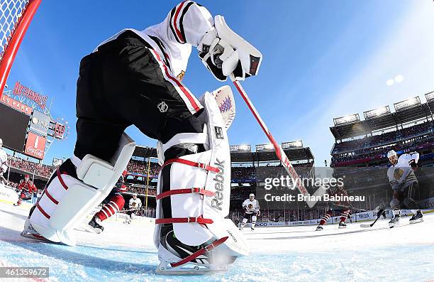 Goaltender Corey Crawford of the Chicago Blackhawks passes the puck from his crease area to defenseman Brent Seabrook during the 2015 Bridgestone NHL...