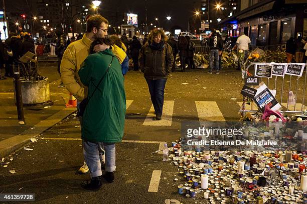 People mourn at a makeshift memorial outside the Hyper Cacher store where 4 hostages were killed, after a mass unity rally following the recent...