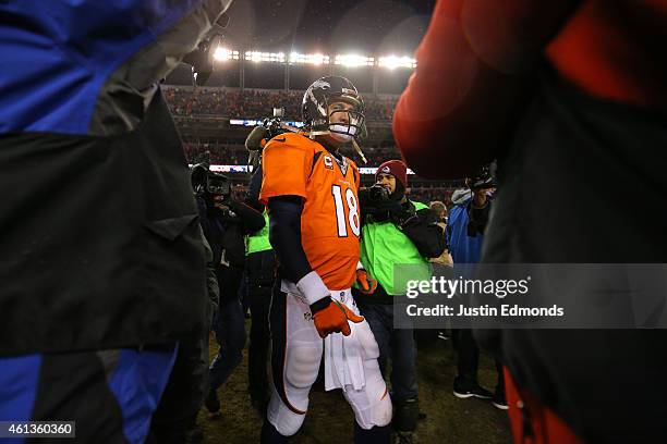 Peyton Manning of the Denver Broncos walks offsides the field after a 13-24 loss against the Indianapolis Colts in a 2015 AFC Divisional Playoff game...