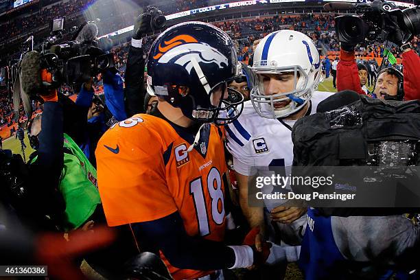 Andrew Luck of the Indianapolis Colts meets Peyton Manning of the Denver Broncos following a 2015 AFC Divisional Playoff game at Sports Authority...