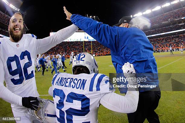 Head coach Chuck Pagano celebrates with Bjoern Werner and Colt Anderson of the Indianapolis Colts after defeating the Denver Broncos 24-13 in a 2015...