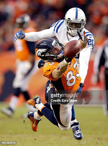 Wes Welker of the Denver Broncos attempts to make a catch as Darius Butler of the Indianapolis Colts defends during a 2015 AFC Divisional Playoff...