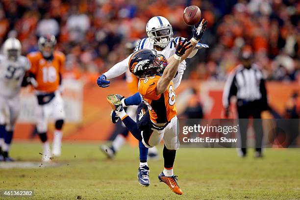 Wes Welker of the Denver Broncos attempts to make a catch as Darius Butler of the Indianapolis Colts defends during a 2015 AFC Divisional Playoff...