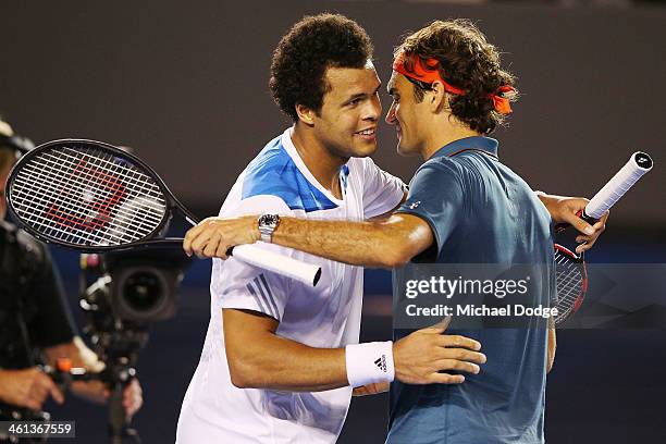 Roger Federer of Switzerland and Jo Wilfried Tsonga of Francce hug after their match during the Roger Federer Charity Match at Melbourne Park on...