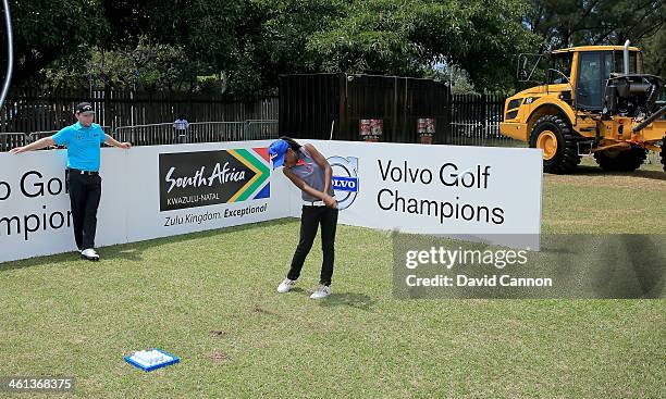 Branden Grace of South Africa conducts a Junior Clinic on the driving range during the pro-am as a preview for the 2014 Volvo Golf Champions...