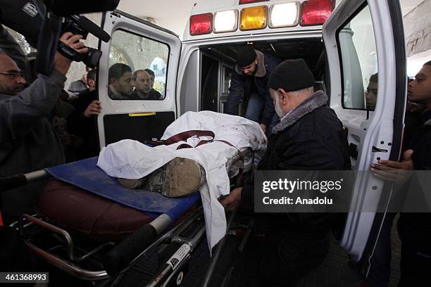 Palestinians carry the body of Islamic Jihad Movement member Mohammed al-Ijlah killed by an Israel soldiers at the Shejaiyah district near Gaza's...