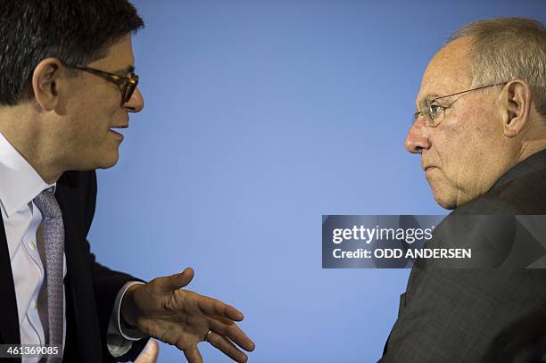 German finance minister Wolfgang Schaeuble and US Treasury Secretary Jack Lew speak after addressing a joint press conference following their meeting...