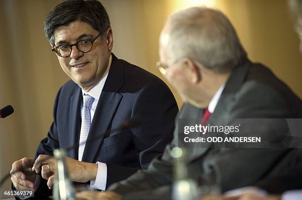 German finance minister Wolfgang Schaeuble and US Secretary of the Treasury Jack Lew address media at a joint press conference following their...