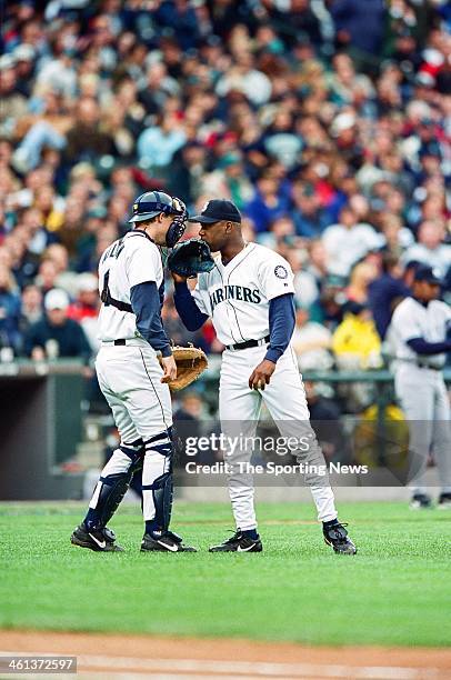 Arthur Rhodes and Dan Wilson of the Seattle Mariners talk during Game Five of the American League Championship Series against the New York Yankees on...