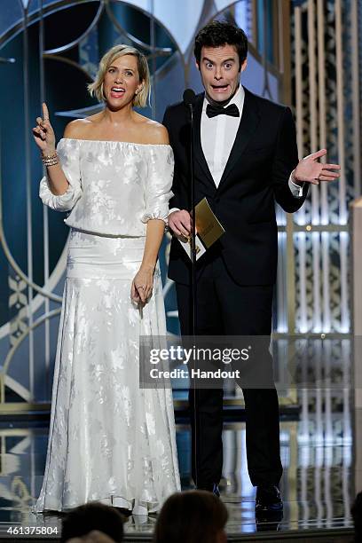 In this handout photo provided by NBCUniversal, Presenters Kristen Wiig and Bill Hader speak onstage during the 72nd Annual Golden Globe Awards at...