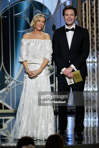 In this handout photo provided by NBCUniversal, Presenters Kristen Wiig and Bill Hader speak onstage during the 72nd Annual Golden Globe Awards at...