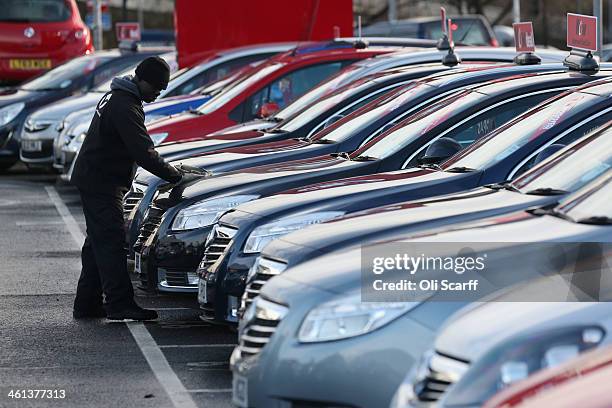 Cars are displayed for sale on the forecourt of a Vauxhall dealership on January 8, 2014 in London, England. Figures from the motor industry have...