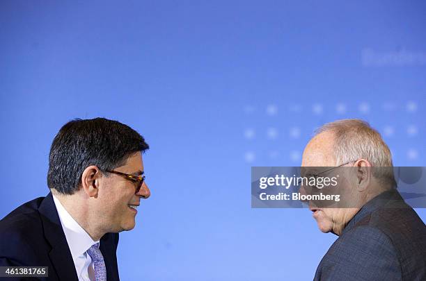 Jacob "Jack" Lew, U.S. Treasury secretary, left, speaks to Wolfgang Schaeuble, Germany's finance minister, during a news conference at the German...