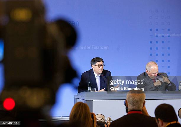 Jacob "Jack" Lew, U.S. Treasury secretary, center, speaks beside Wolfgang Schaeuble, Germany's finance minister, during a news conference at the...