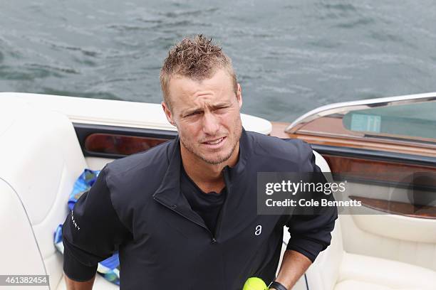 Llewton Hewitt stands in speed boat before a game of 'speed boat tennis' on Sydney Harbour with Roger Federer