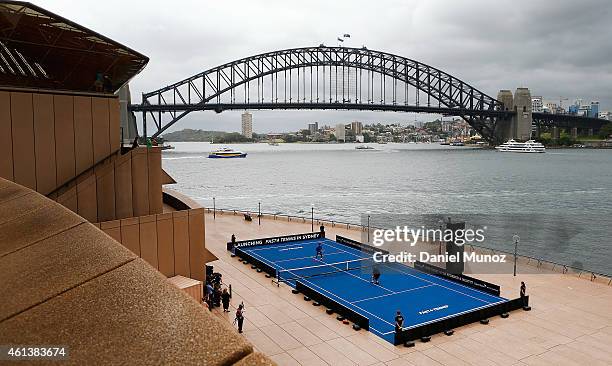 Roger Federer of Switzerland and Lleyton Hewitt of Australia hit some balls during the launch of Fast 4 Tennis in front of the Sydney Harbour Bridge...