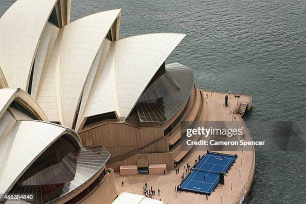 Roger Federer of Switzerland plays tennis with Lleyton Hewitt of Australia on the forecourt of the Sydney Opera House ahead of their Fast 4...