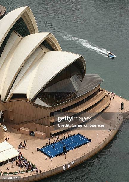 Roger Federer of Switzerland plays tennis with Lleyton Hewitt of Australia on the forecourt of the Sydney Opera House ahead of their Fast 4...