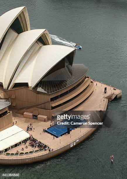 Roger Federer of Switzerland plays tennis with Lleyton Hewitt of Australia on the forecourt of the Sydney Opera House ahead of their Fast 4...
