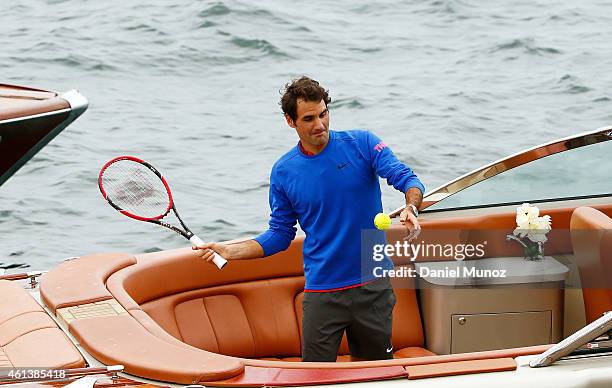 Roger Federer of Switzerland hits a tennis ball from a boat before the launch of Fast 4 Tennis on January 12, 2015 in Sydney, Australia.