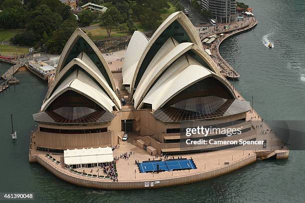 Roger Federer of Switzerland plays tennis with Lleyton Hewitt of Australia on the forecourt of the Sydney Opera House ahead of their Fast 4...