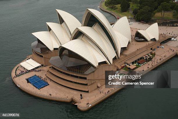 Roger Federer of Switzerland plays tennis with Lleyton Hewitt of Australia on the forecourt of the Sydney Opera House ahead of their Fast 4...