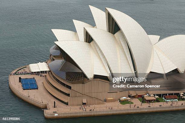 Roger Federer of Switzerland plays tennis with Lleyton Hewitt of Australia on the forecourt of the Sydney Opera House ahead of their Fast 4...