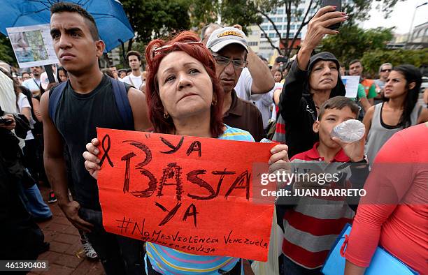 People gather in a demonstration to protest over the death of former beauty queen turned soap opera star Monica Spear, in Caracas on January 8, 2014....