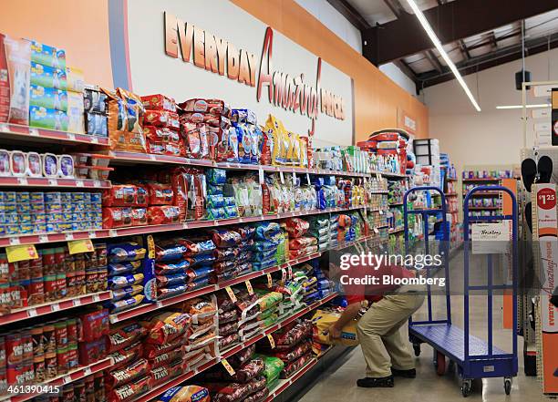 Store manager stocks dog food at a Family Dollar Stores Inc. Location in Mansfield, Texas, U.S., on Tuesday, Jan. 7, 2014. Family Dollar Stores Inc....