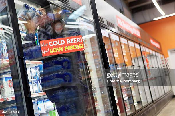 Delivery man stocks beer at a Family Dollar Stores Inc. Location in Mansfield, Texas, U.S., on Tuesday, Jan. 7, 2014. Family Dollar Stores Inc. Is...