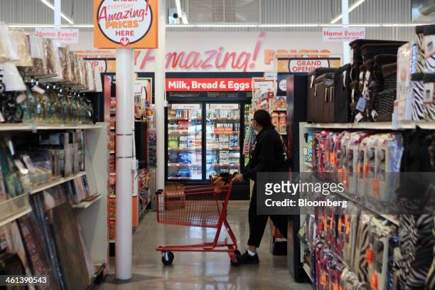 Woman rolls a shopping cart inside a Family Dollar Stores Inc. Location in Mansfield, Texas, U.S., on Tuesday, Jan. 7, 2014. Family Dollar Stores...