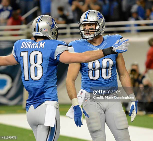 Kris Durham and Joseph Fauria of the Detroit Lions celebrate a touchdown during the game against the New York Giants at Ford Field on December 22,...