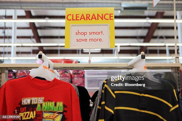 Clearance clothing items hang on display at a Family Dollar Stores Inc. Location in Mansfield, Texas, U.S., on Tuesday, Jan. 7, 2014. Family Dollar...