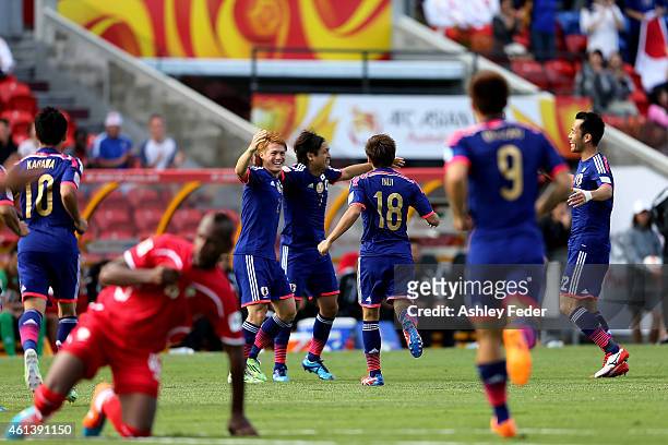 Japan celebrate the first goal by Yasuhito Endo during the 2015 Asian Cup match between Japan and Palestine at Hunter Stadium on January 12, 2015 in...