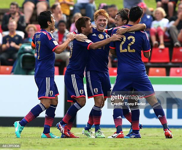 Japan players celebrate their first goal by Yasuhito Endo during the 2015 Asian Cup match between Japan and Palestine at Hunter Stadium on January...